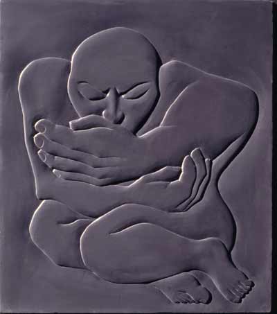 Image of slate carving depicting solitary huddled figure.